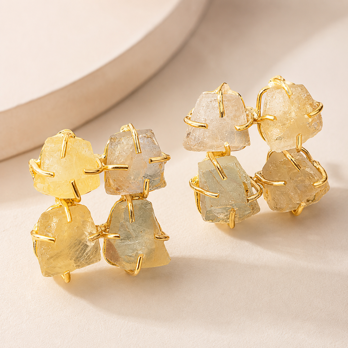 Angled view of rough citrine gold plated stud earrings with an organic cluster design.