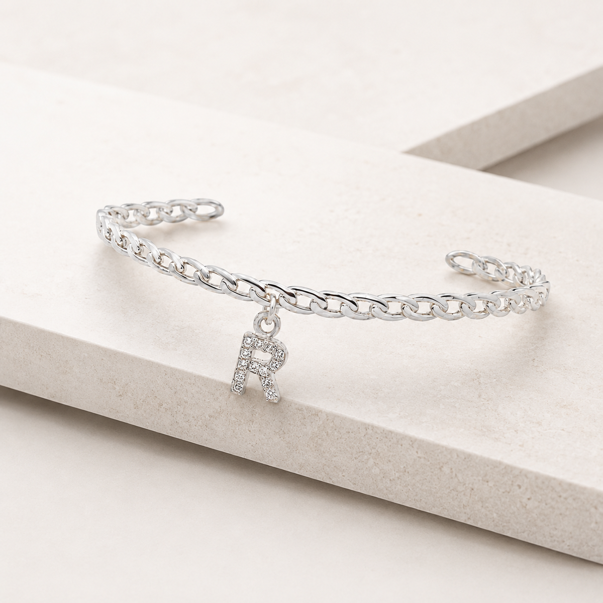 Angled view of a personalized CZ initial cuff bracelet.
