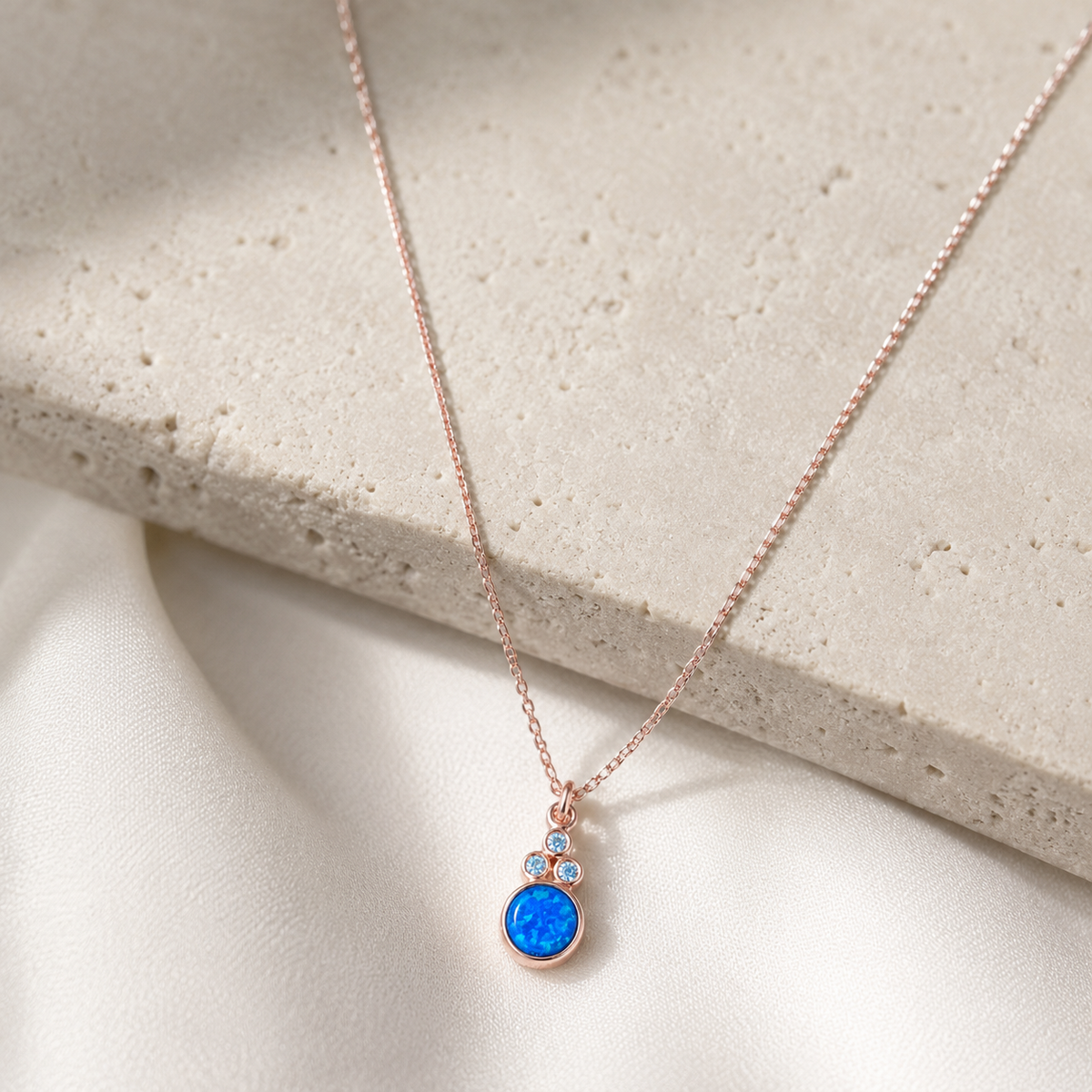 Front view of a blue opal necklace with a slim chain and small accent stones.