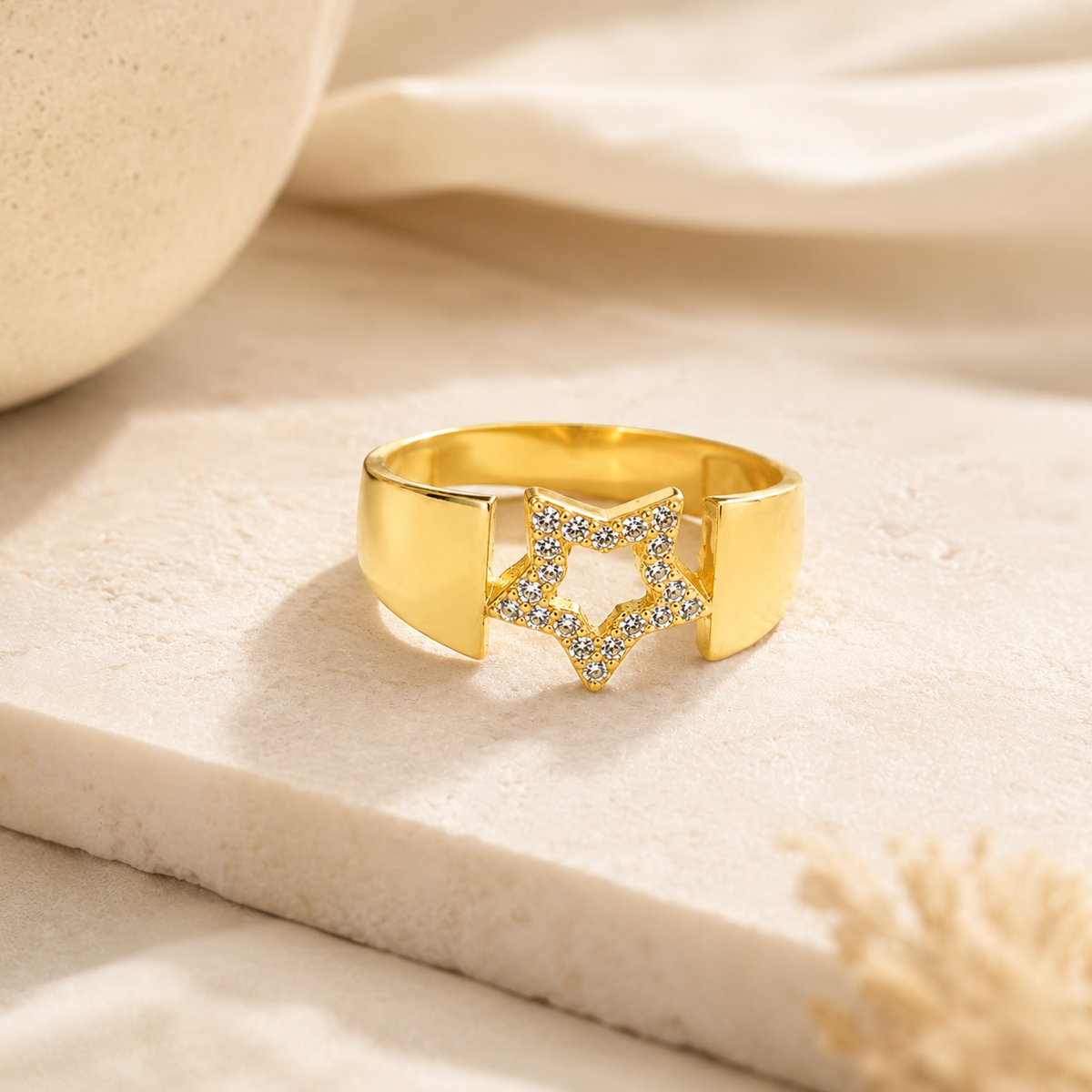 Angled view of a wide gold-plated statement ring with CZ accents.