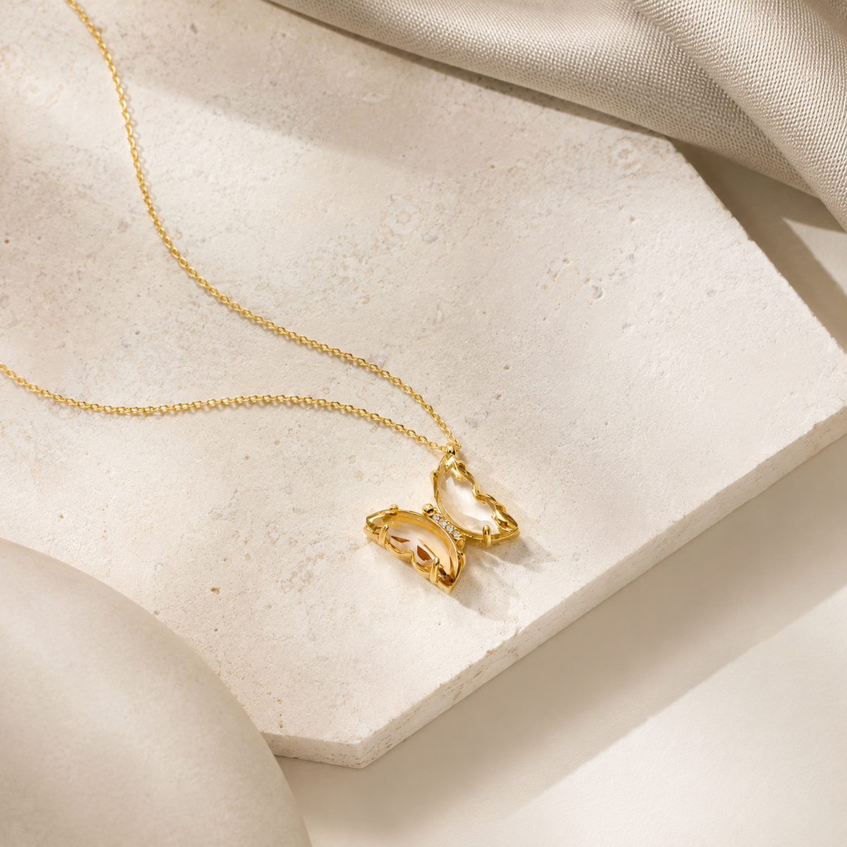 Angled view of the butterfly pendant necklace with crystal detail.