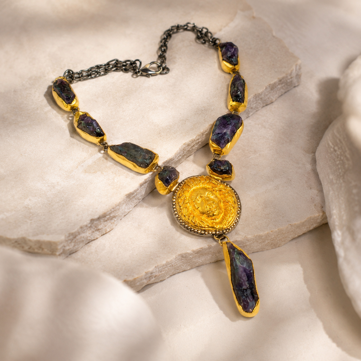 Angled view of the purple raw stone necklace with gold-tone settings.