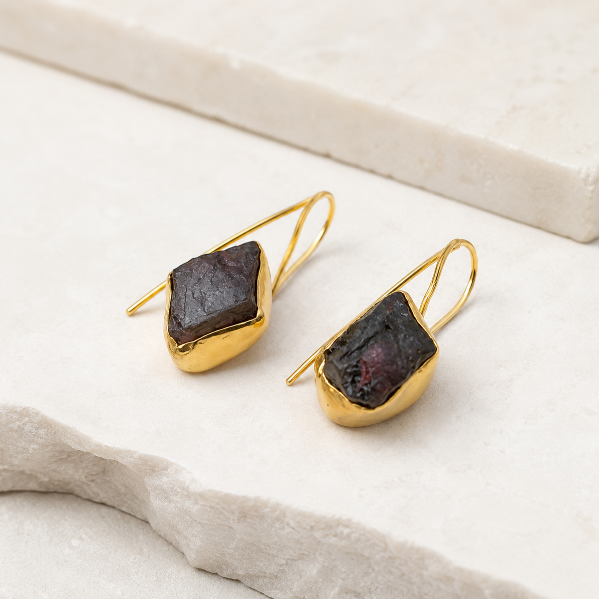 Angled view of gold-plated drop earrings with green agate slice stones.