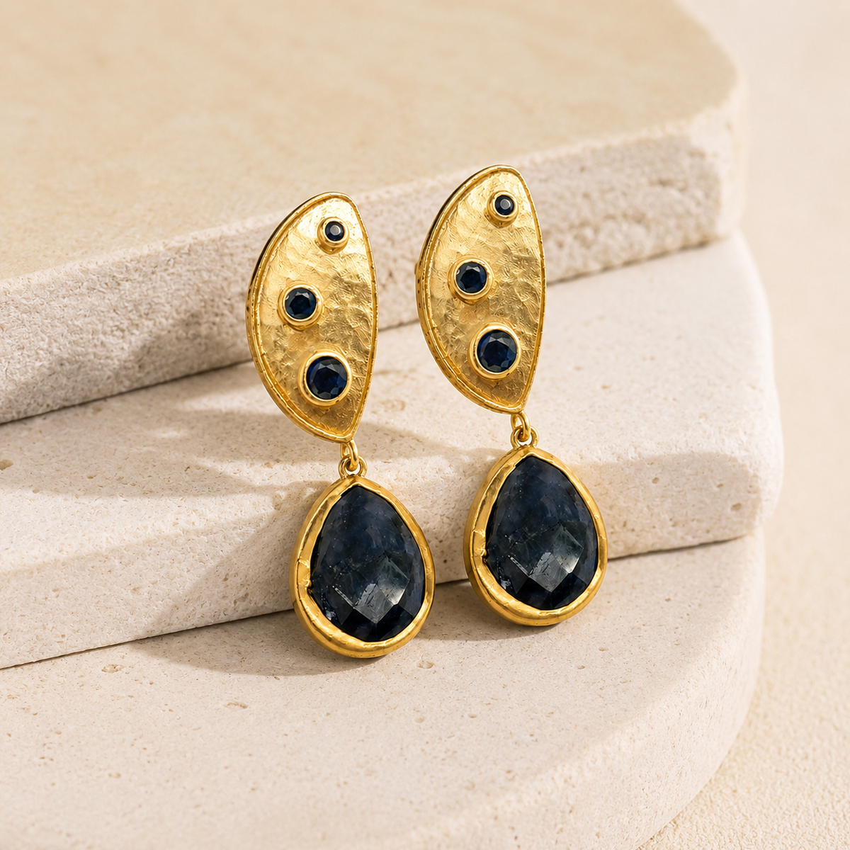 Angle view of gold plated half moon dangle earrings.