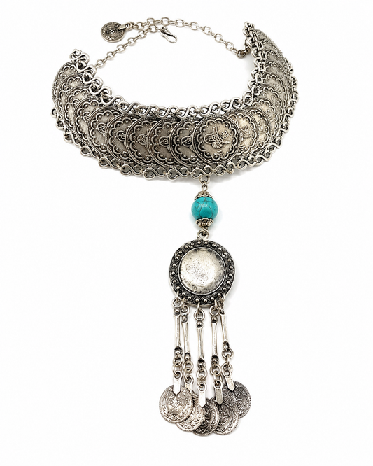 Silver-tone coin choker necklace with a turquoise accent and tassel drop.