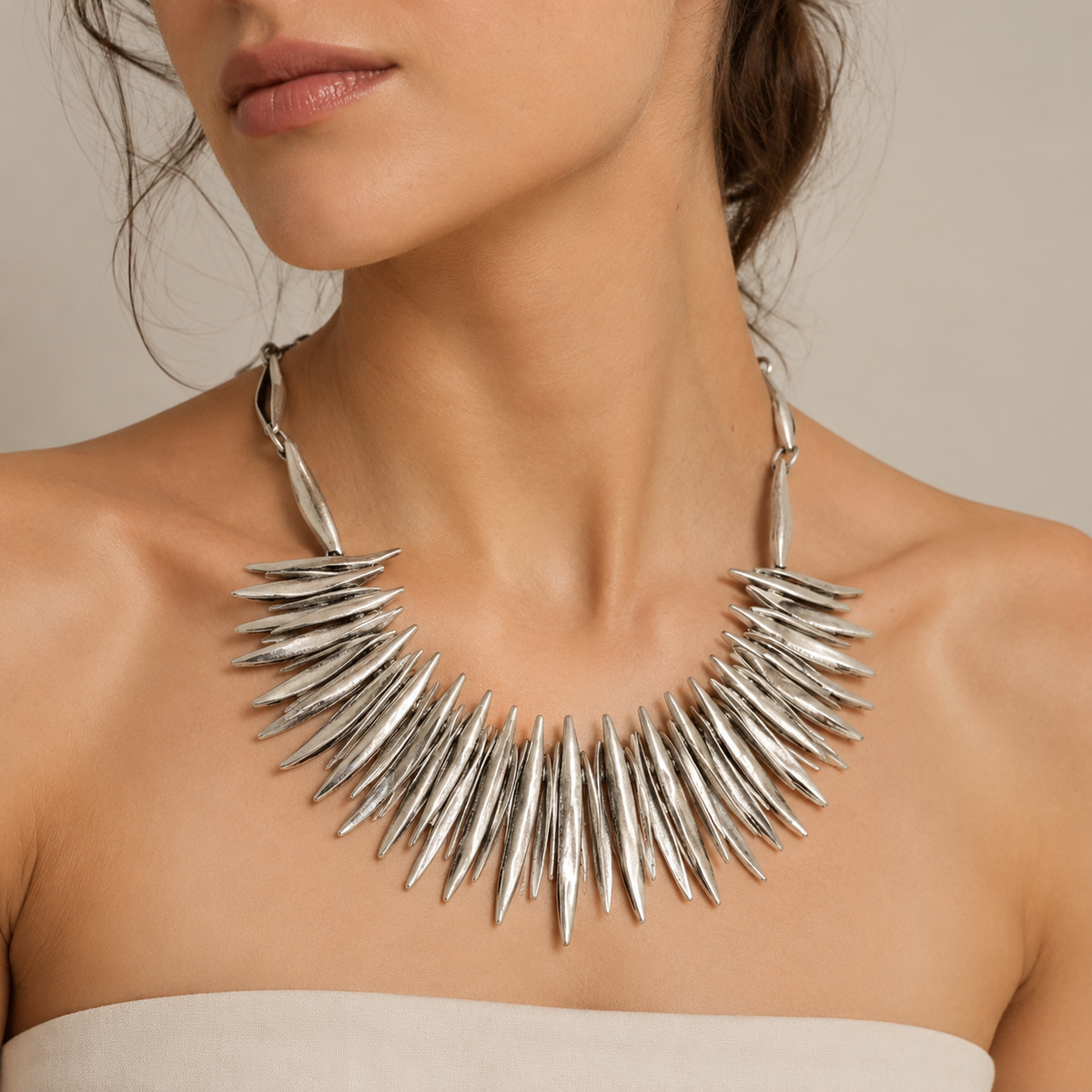 Silver-tone spiky collar necklace shown on a white background.
