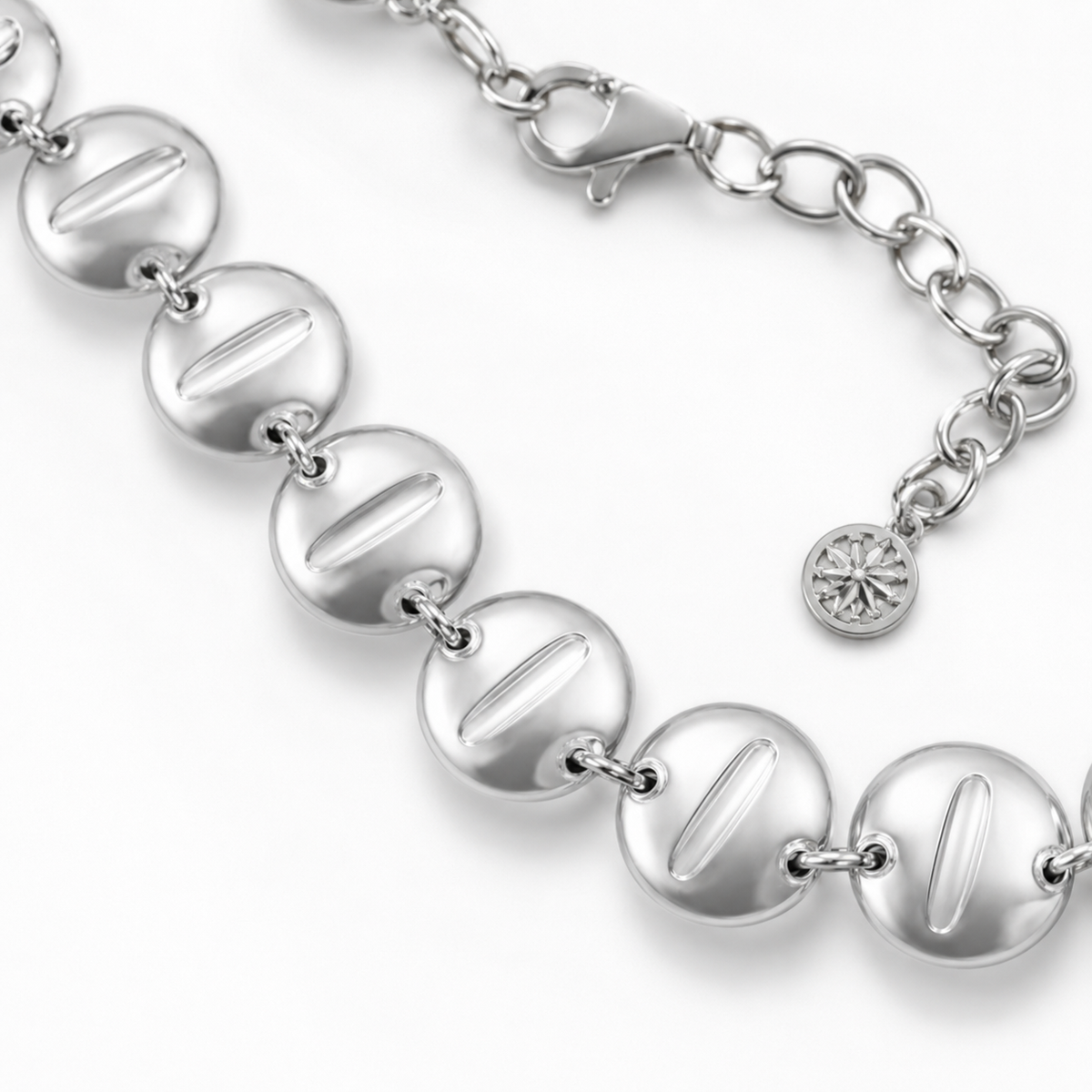 Close view of the polished round disc links and clasp detail.