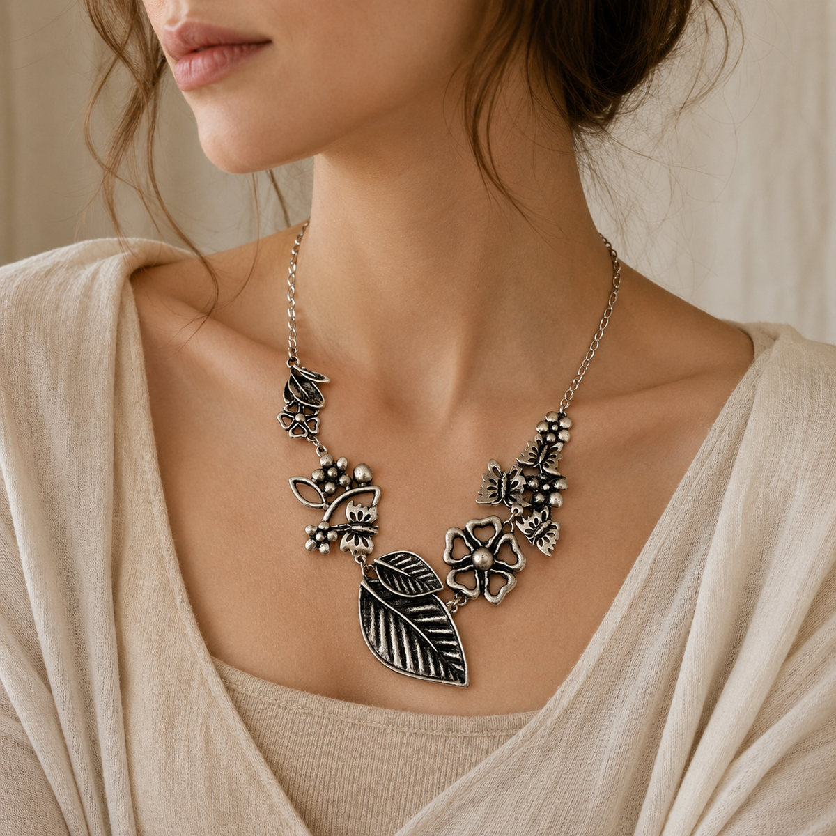 Floral and leaf statement necklace with a silver-tone finish.