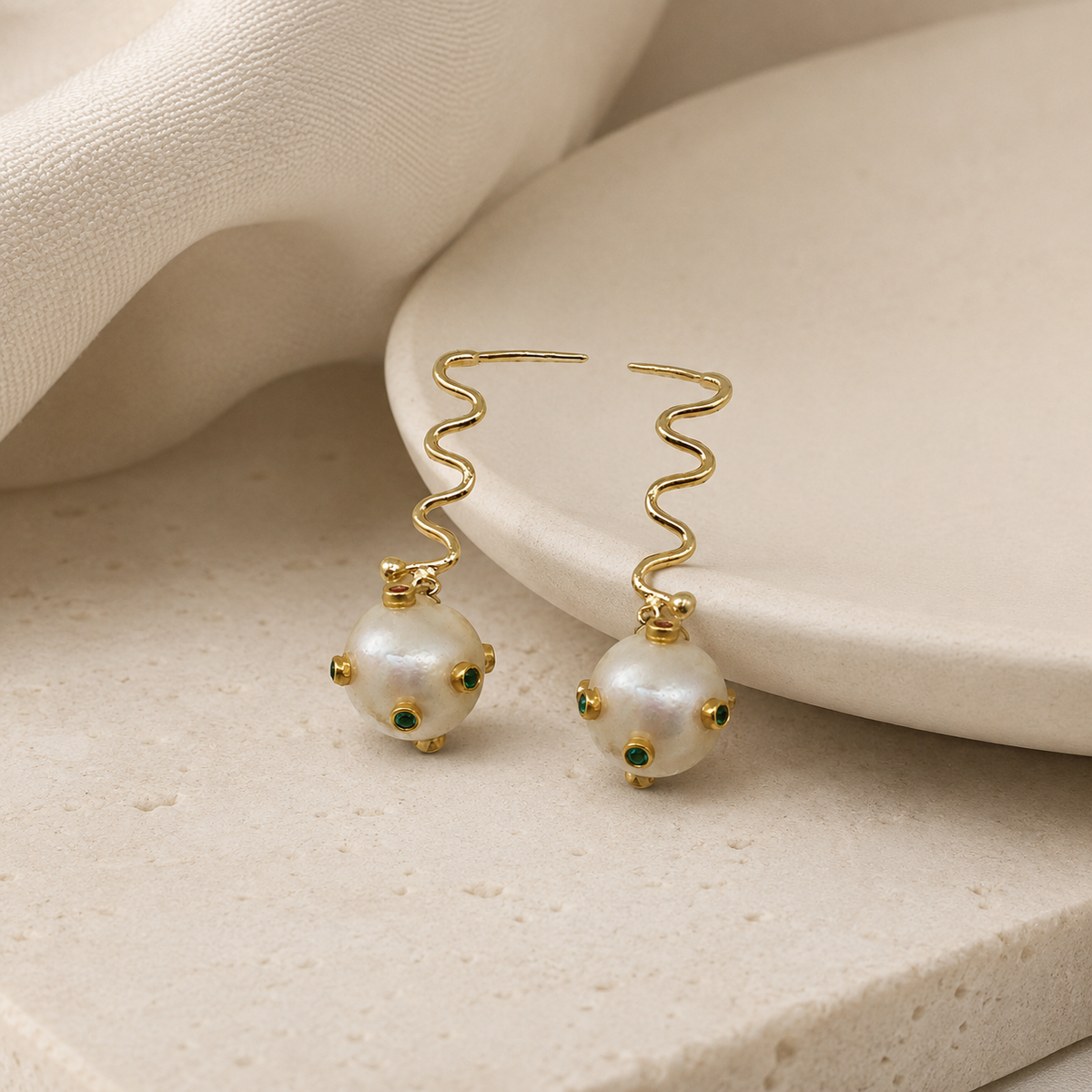 Minimal gold-plated drop earrings with a modern wavy silhouette.