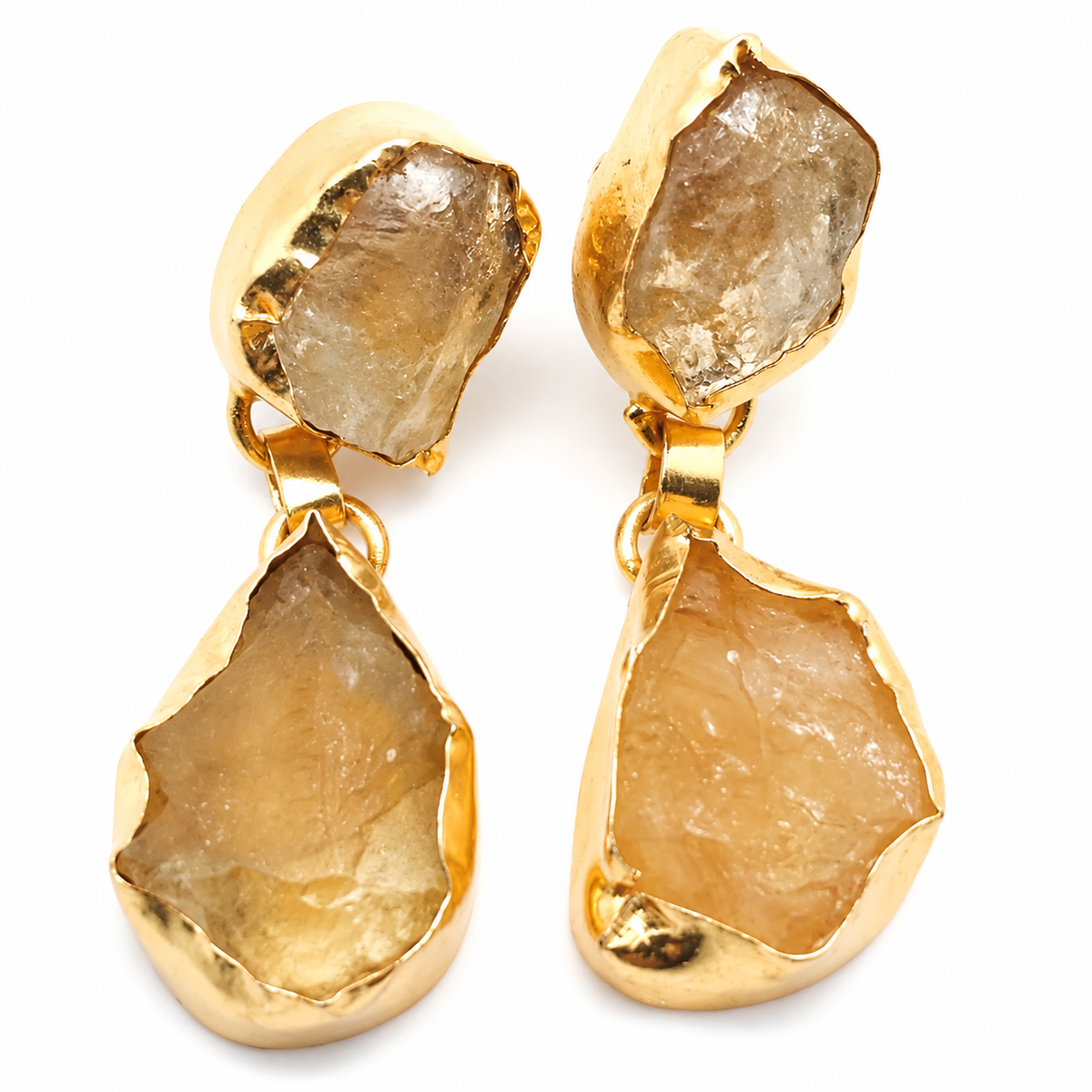 Gold-plated drop earrings with rough citrine-like stones on a white background.