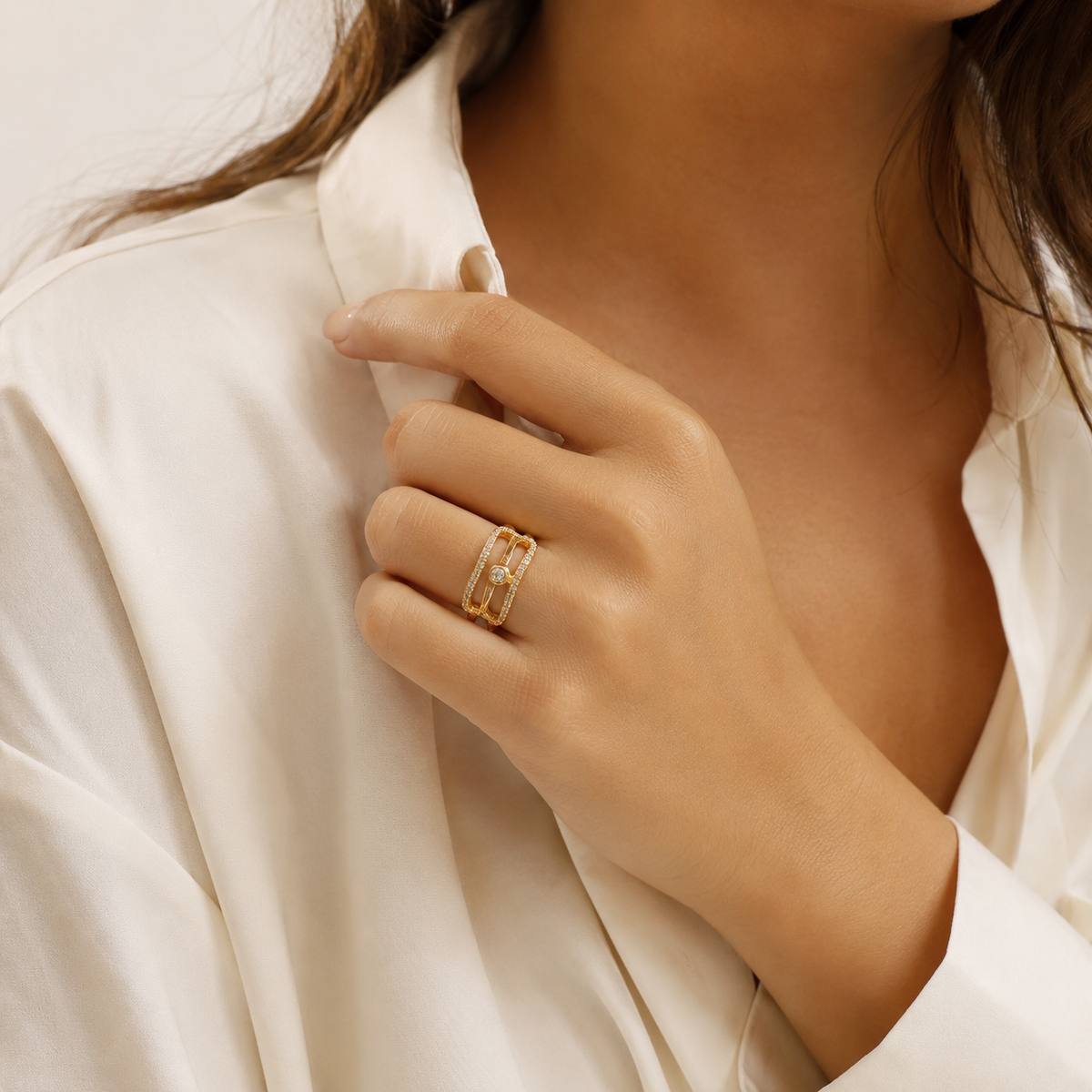 Minimalist gold-tone ring with three curved bands and CZ accents.