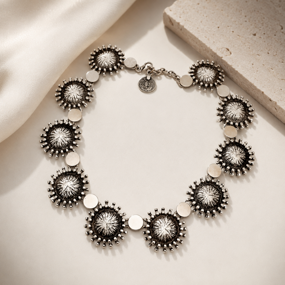 Silver-tone sunburst disc collar necklace with a sculptural, statement look.