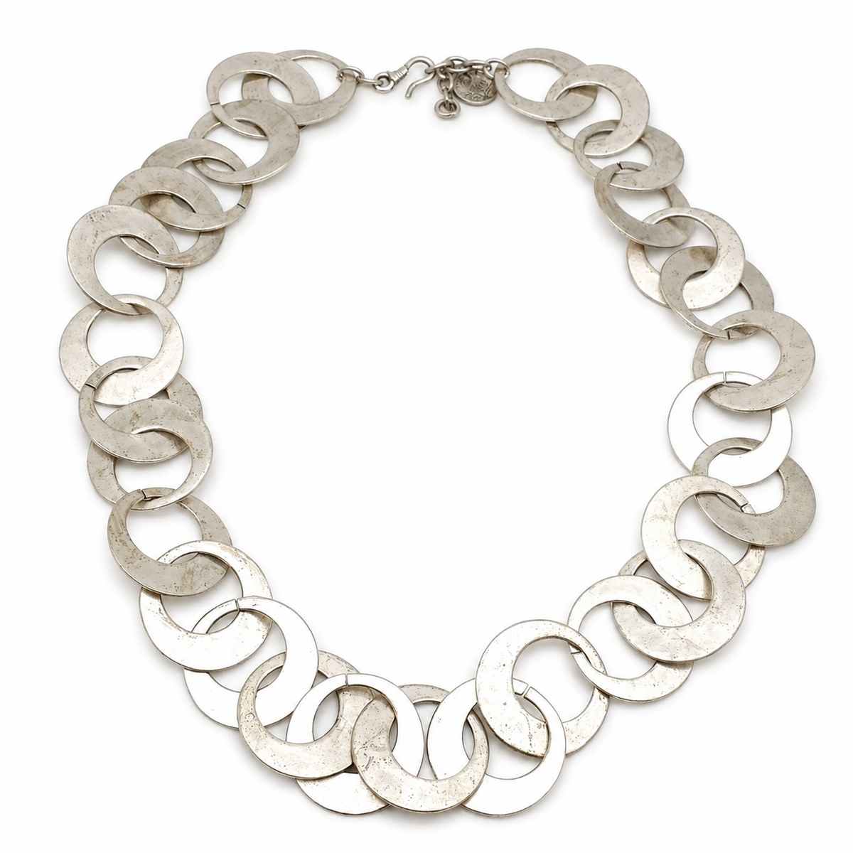 Silver-tone necklace with smooth linked circle shapes arranged in a bold chain.