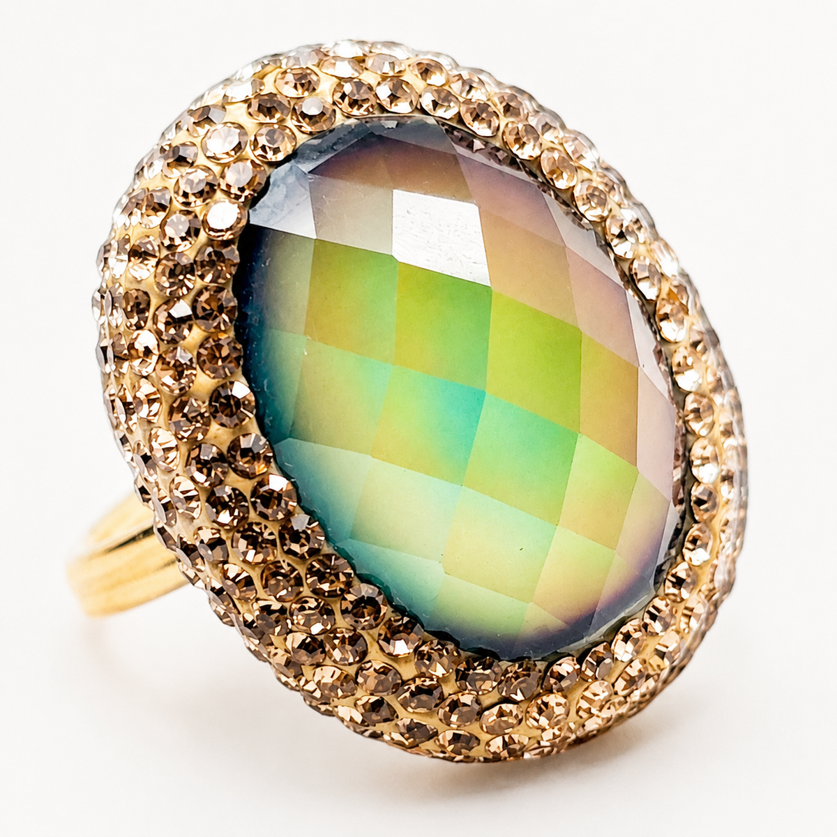 Close view of the faceted mood stone-style center and CZ halo on a gold-plated ring.