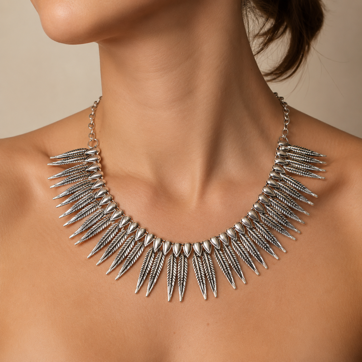 Silver-tone collar necklace shown on a white background.