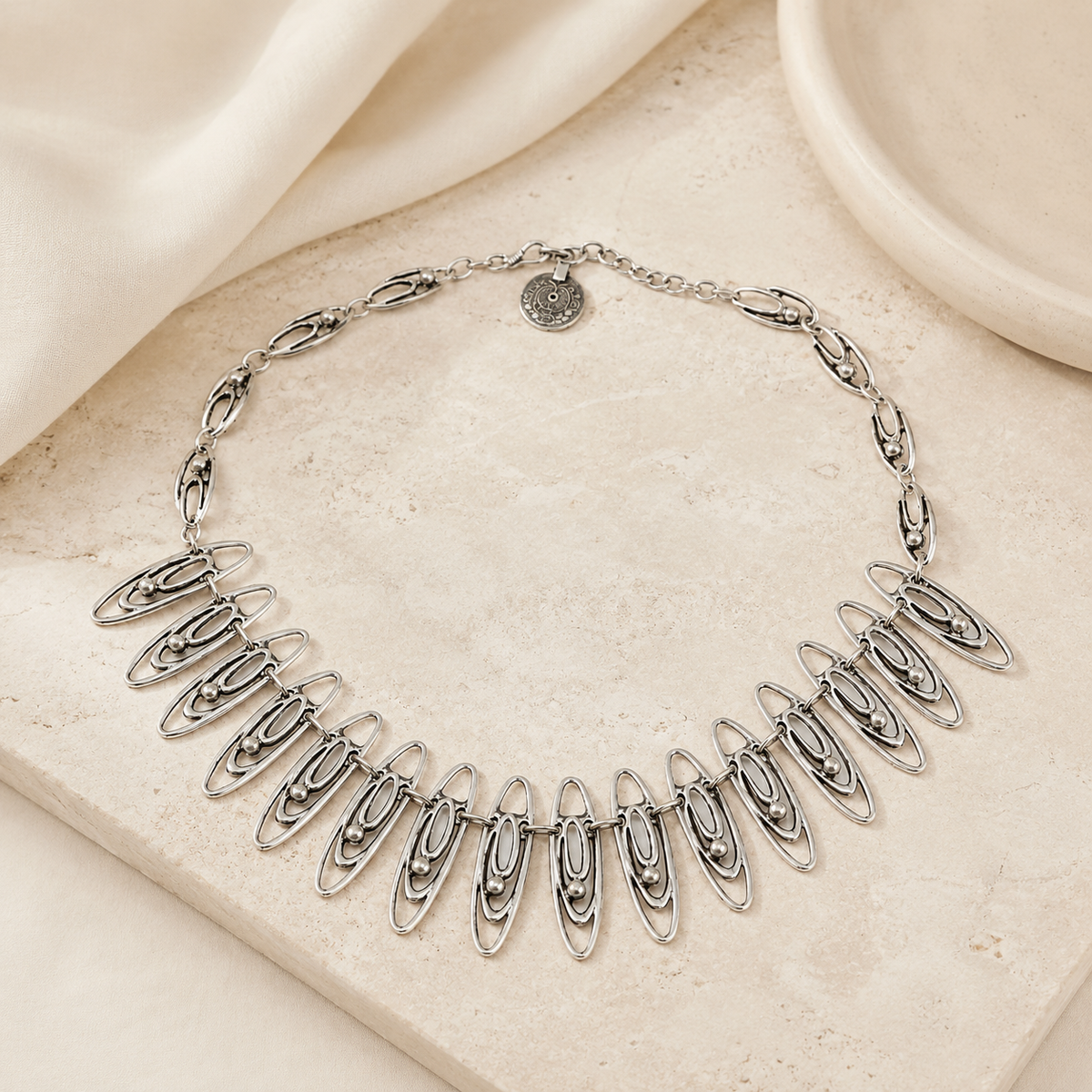 Oval link necklace styled as a bold neckline piece.