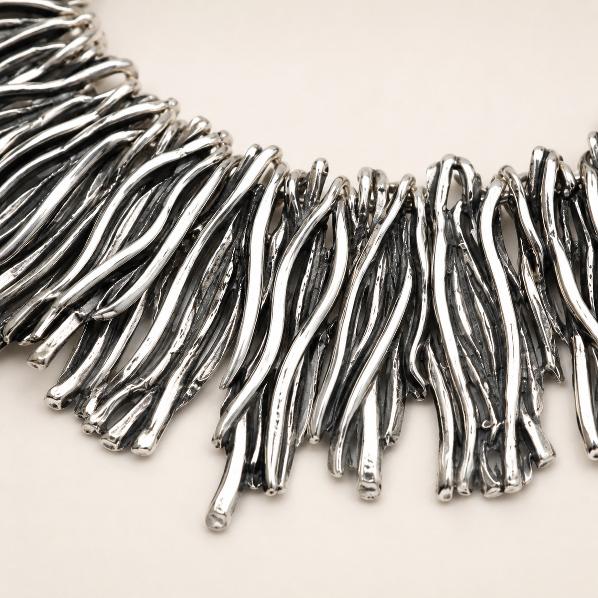 Close-up of the silver-tone fringe detail and textured links.