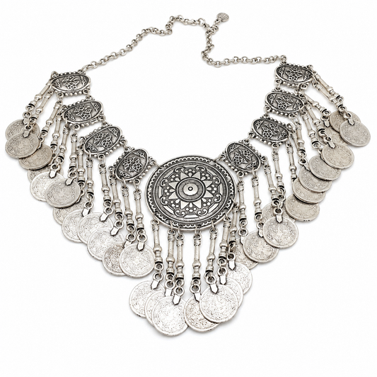 Silver-tone statement necklace with a large medallion center and layered coin fringe.
