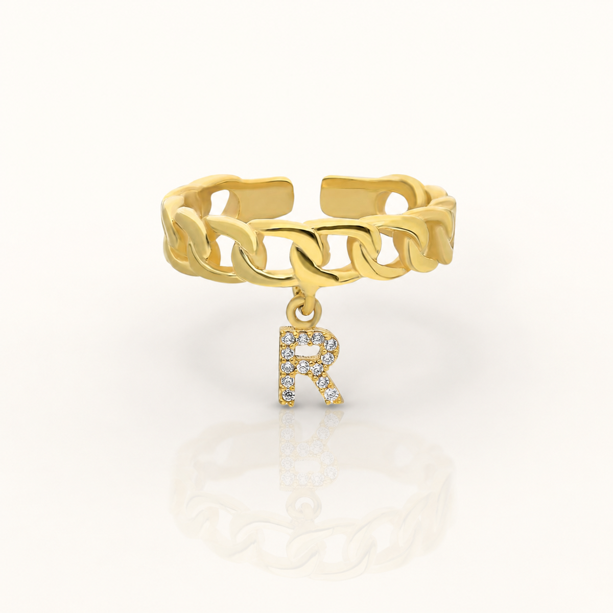 Gold-tone chain ring with a CZ initial charm.