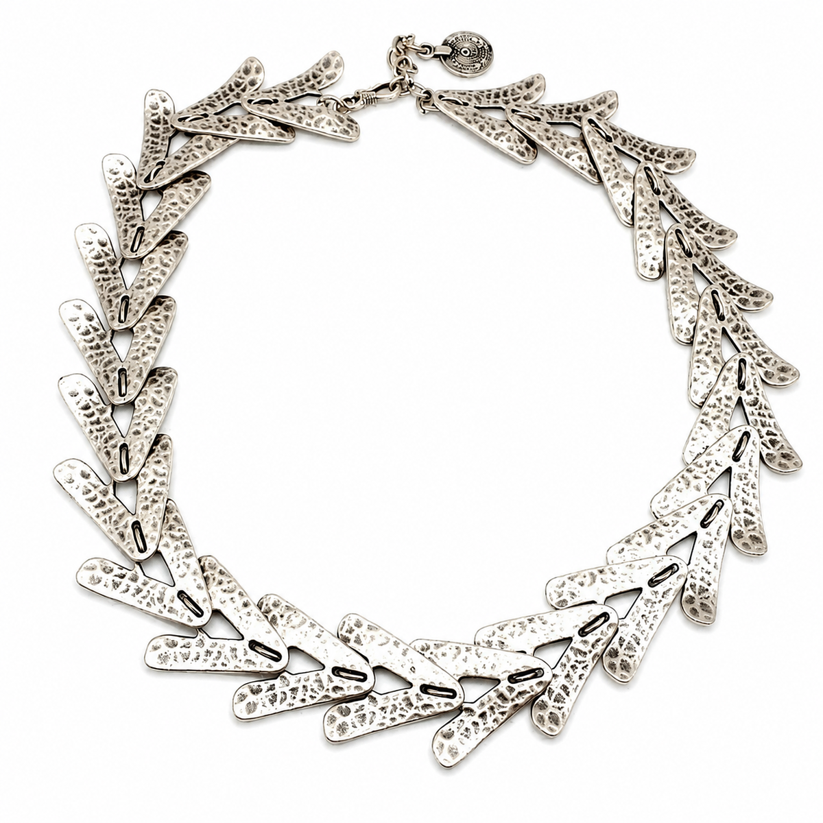 Silver-tone collar necklace with textured arrow-shaped links arranged in a bold circular silhouette.