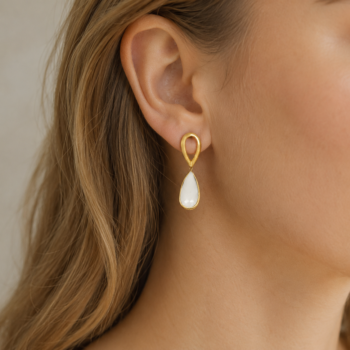 Hammered gold-plated drop earrings shown on a white background.