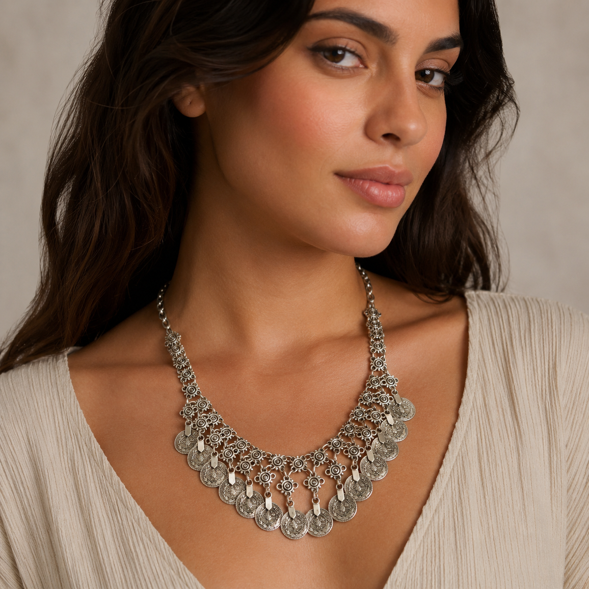 Silver-tone floral coin fringe necklace shown on a white background.