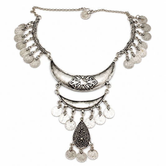 Silver-tone bib necklace with lattice-inspired detailing and coin fringe.