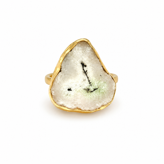 Solar quartz slice ring with a gold-plated organic frame on a white background.
