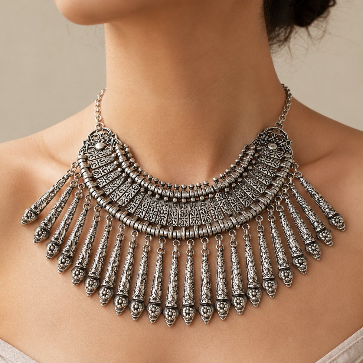 Silver-tone boho collar necklace with layered paddle fringe and intricate textured details.