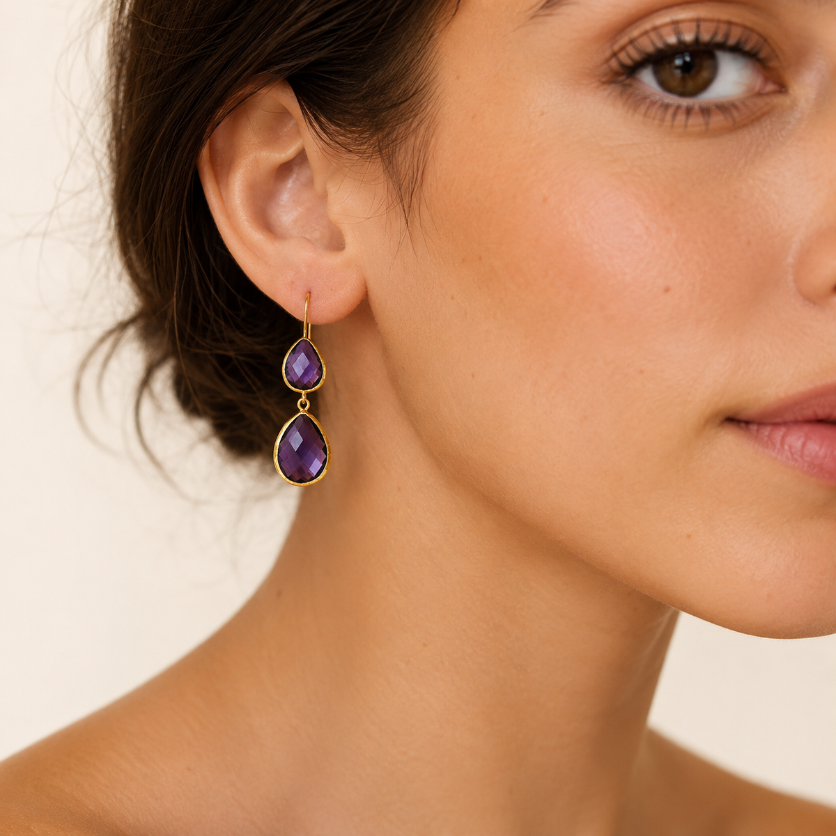 Gold-plated drop earrings with faceted amethyst stones.