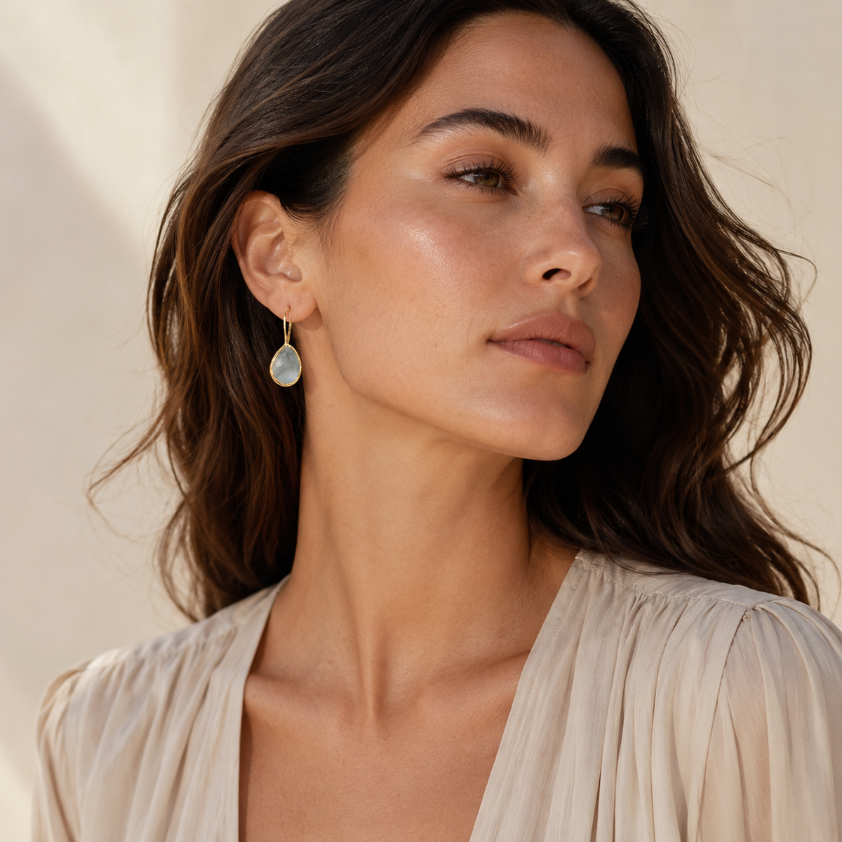 Pair of teardrop earrings with faceted rutilated quartz stones and gold-plated frames.