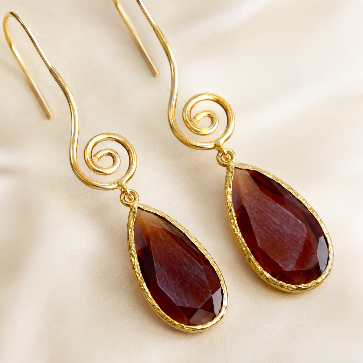 Close view of the spiral detail and brown teardrop accent on the earrings.