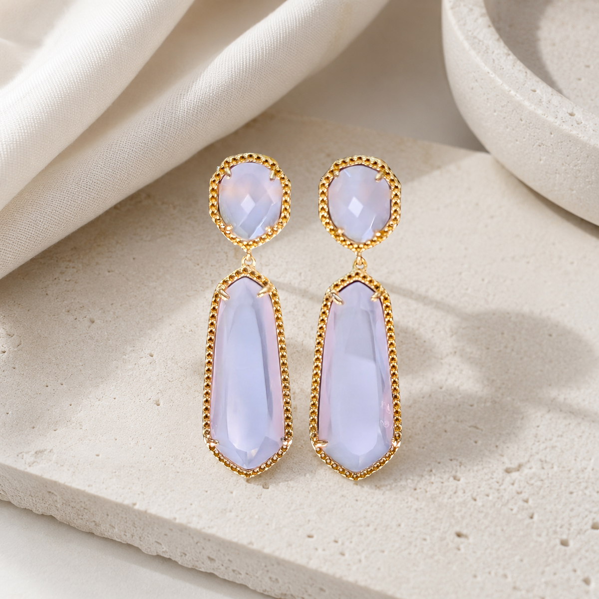 Lavender and gold-tone drop earrings with a long, elegant silhouette.