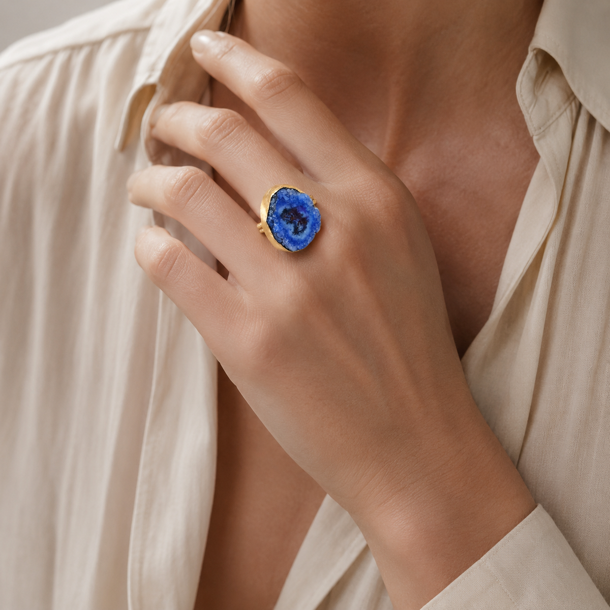 Blue druzy agate ring with a bold round stone and gold-tone band.