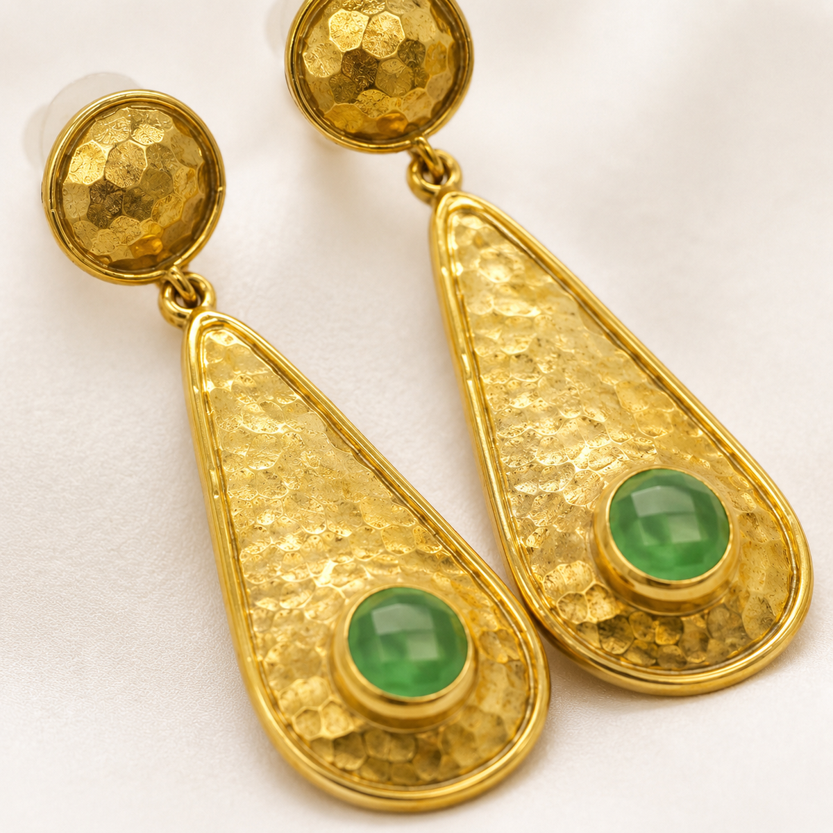 Close view of the hammered texture and green stone detail.