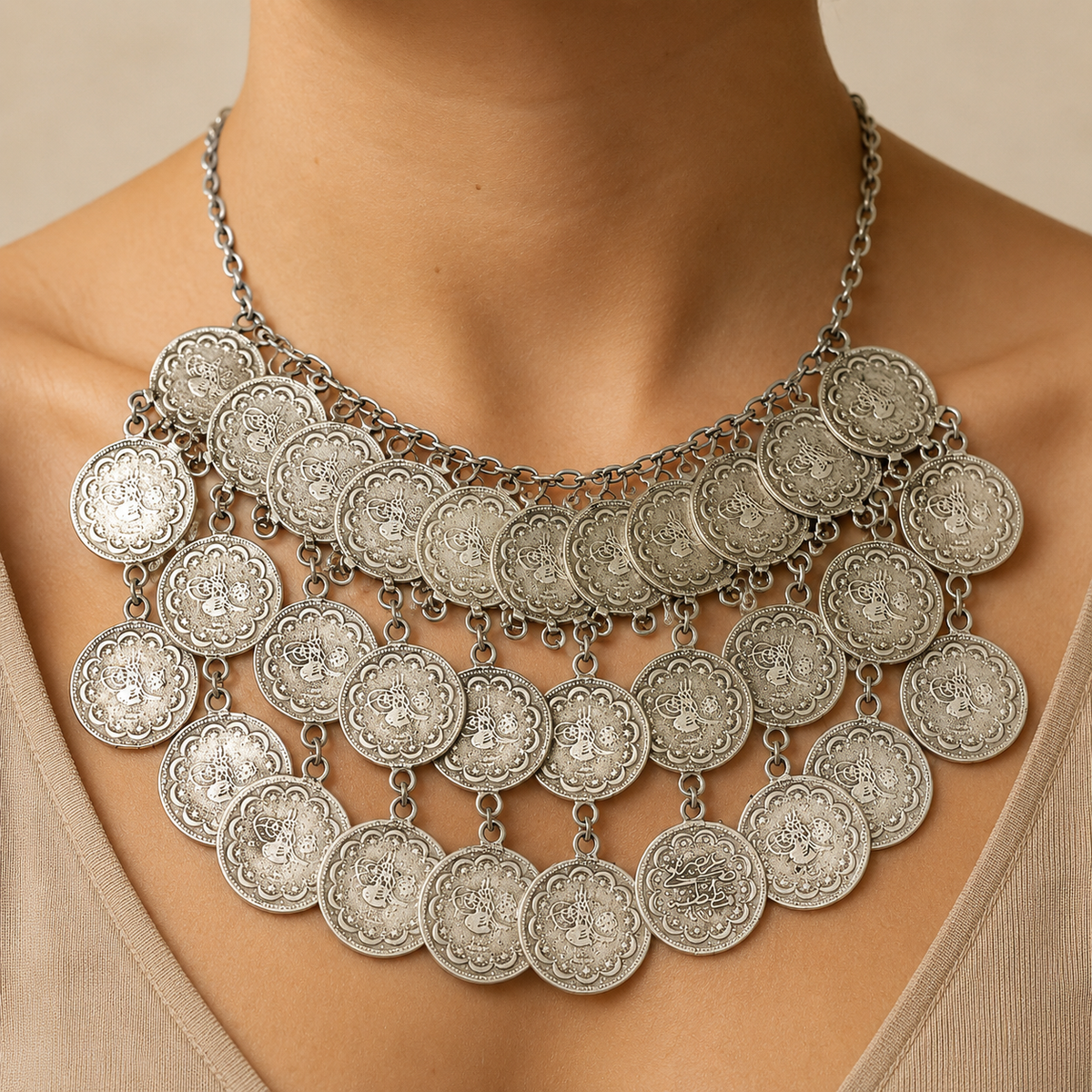 Silver-tone layered coin necklace shown from the front on a white background.