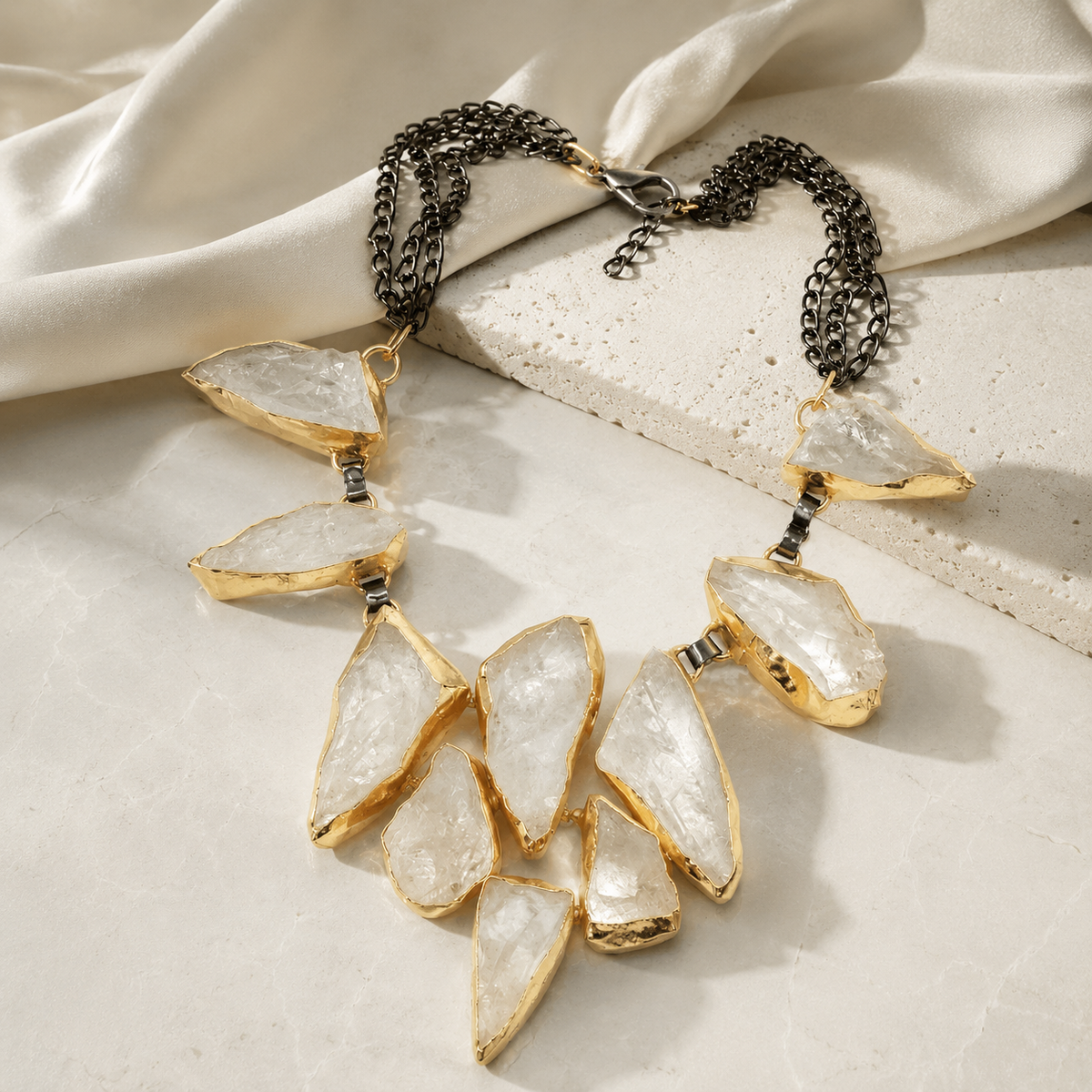 Rock crystal statement necklace with sculptural clear stones and a bold pendant shape.