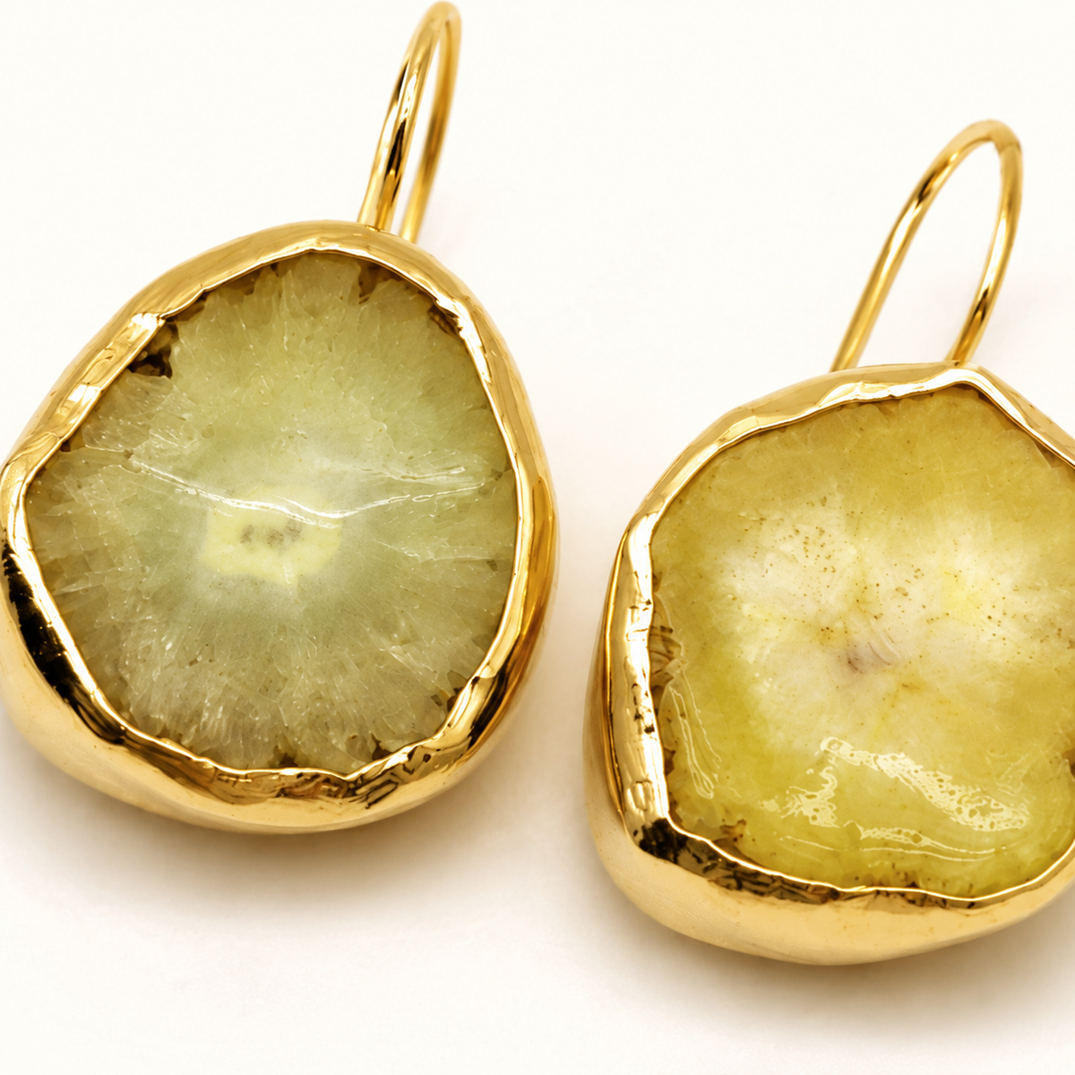 Close view of the raw garnet stone texture and gold-plated setting.