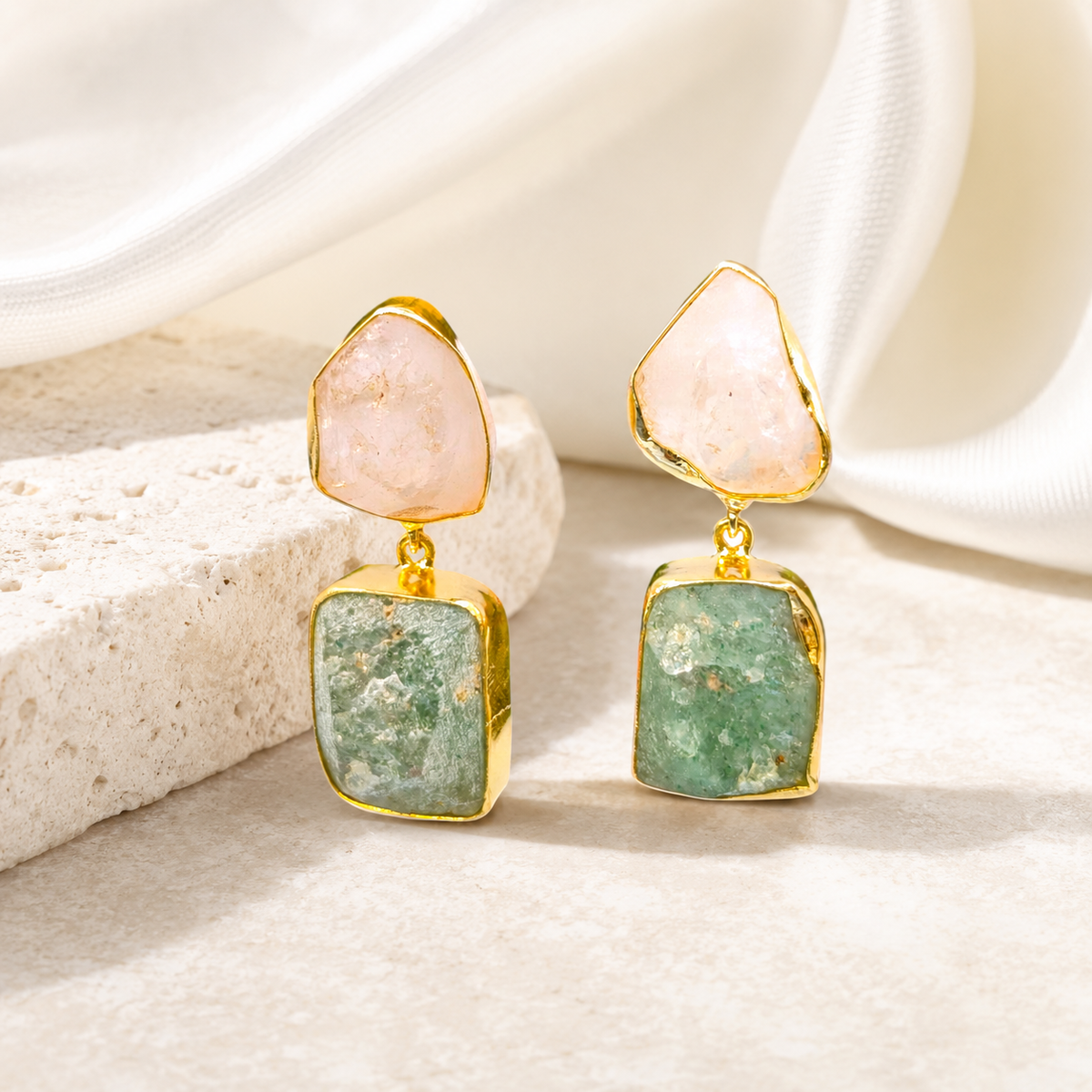 Gold plated drop earrings with textured rose quartz and apatite stones on a white background.