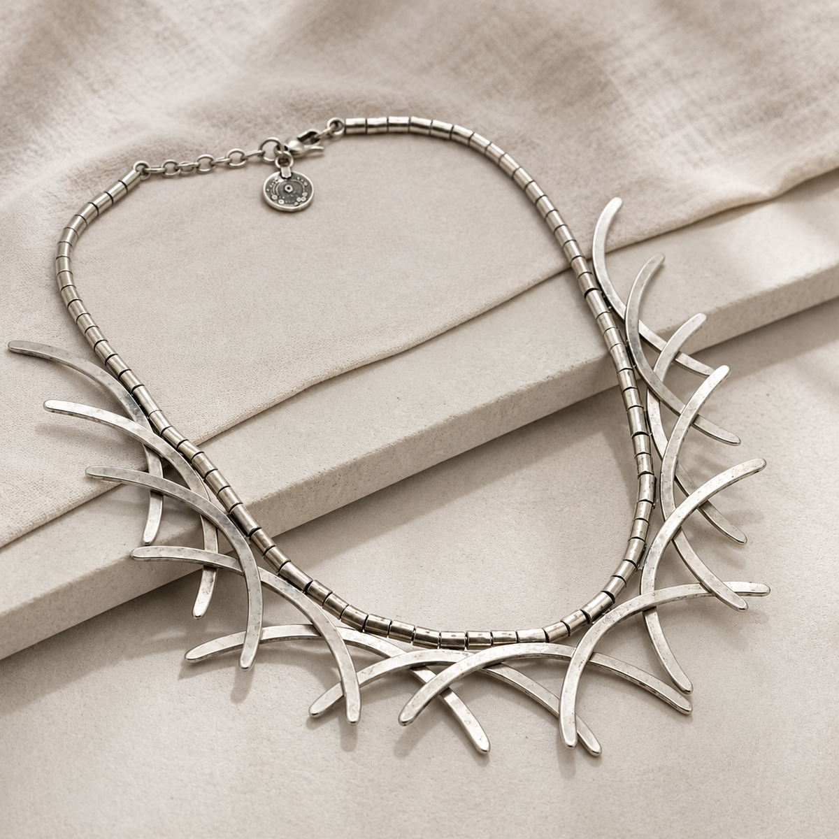 Angled view of the silver-tone abstract branch collar necklace.