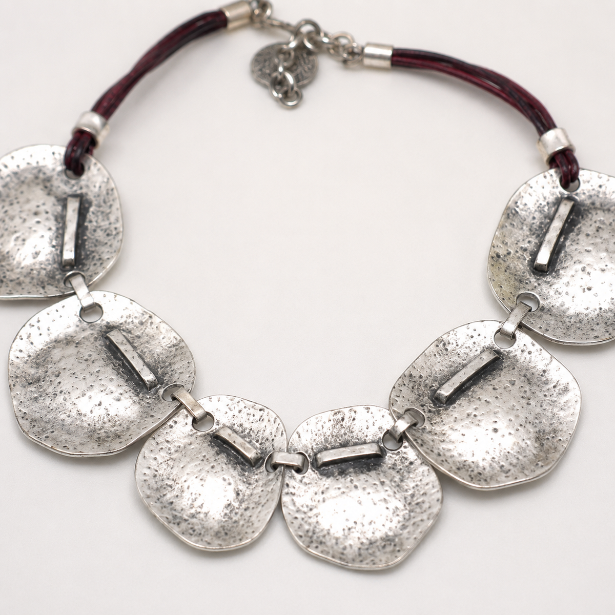 Close view of the textured silver plates and linked connectors.