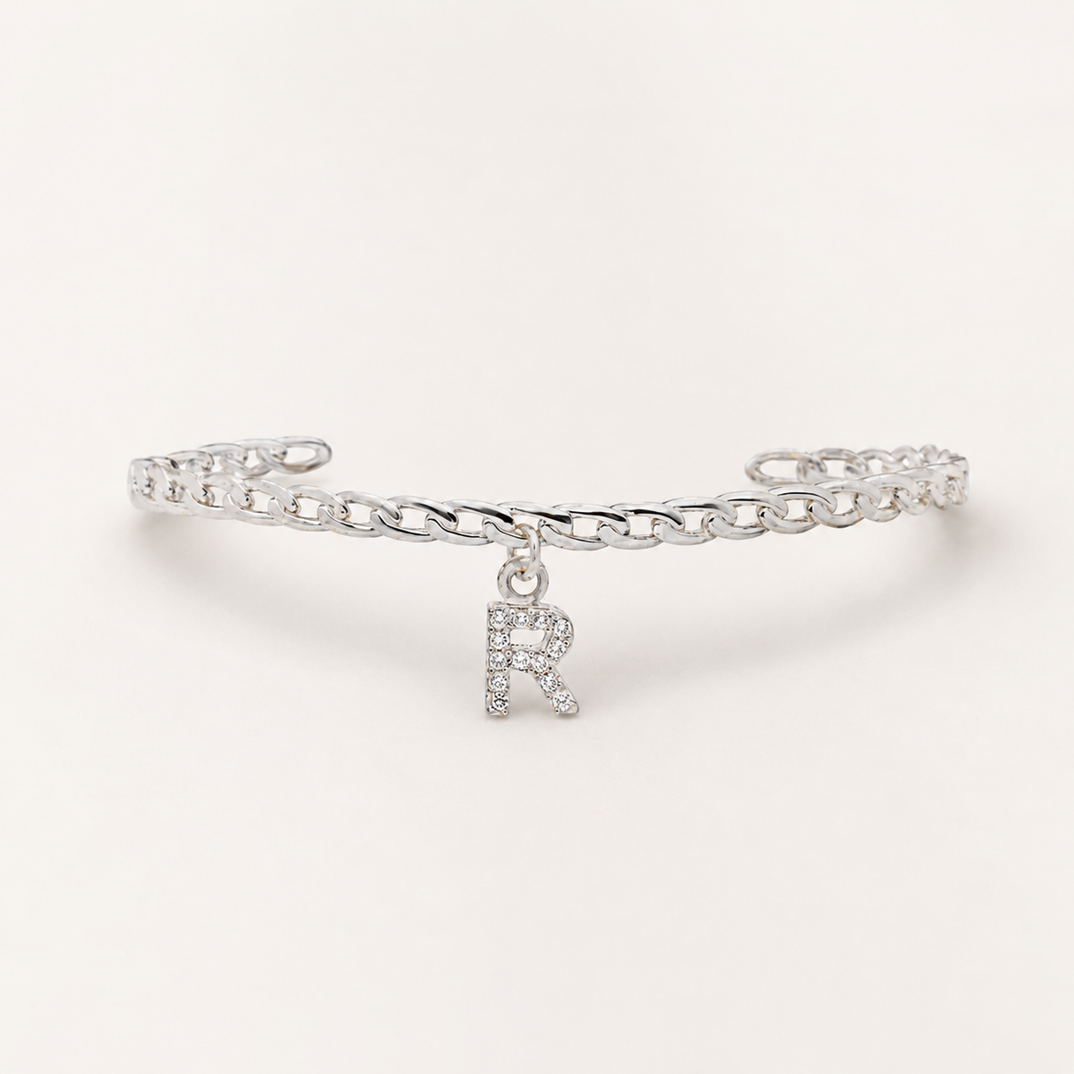 Silver-tone cuff bracelet with a CZ initial charm.