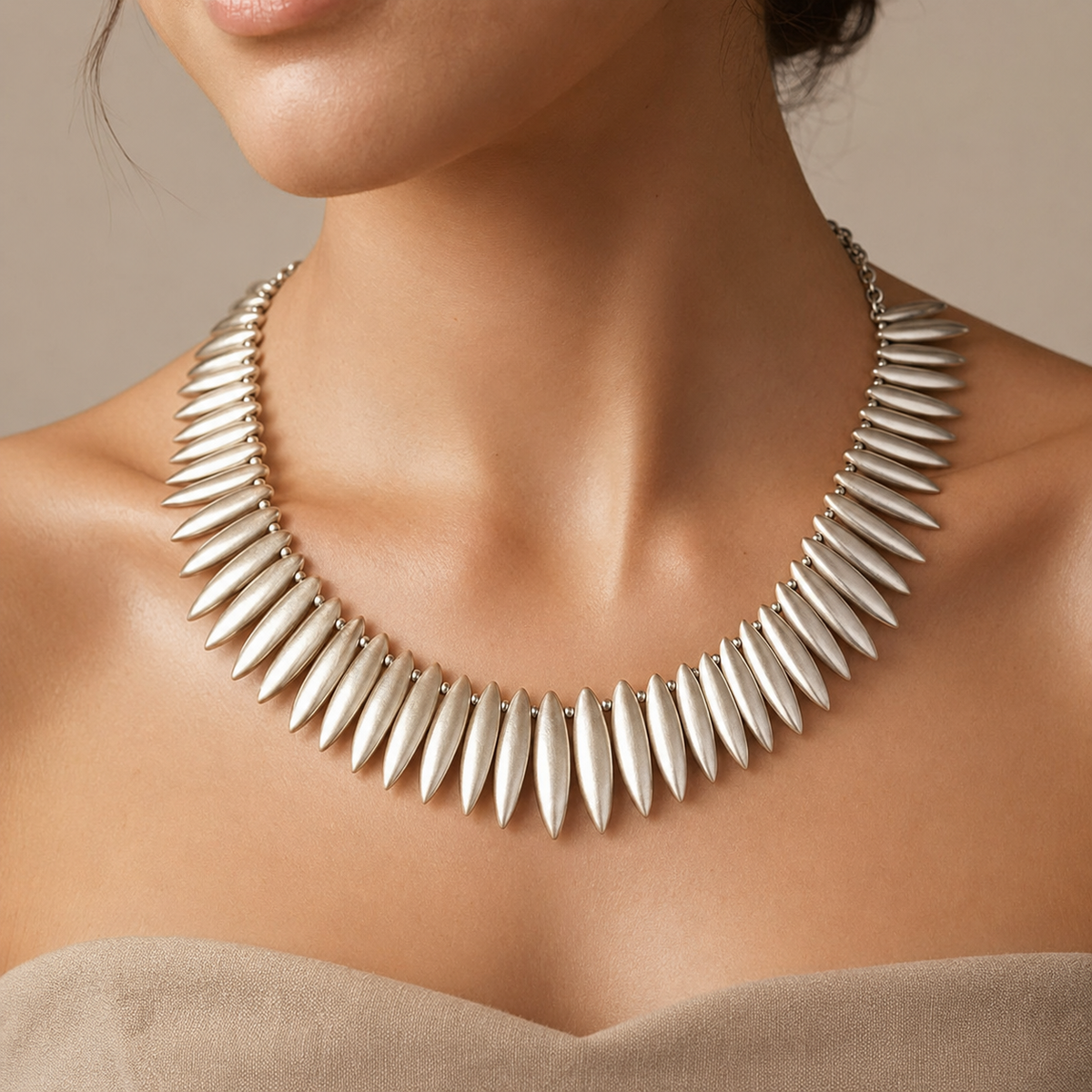 Silver-tone leaf spike collar necklace shown in a clean front view.