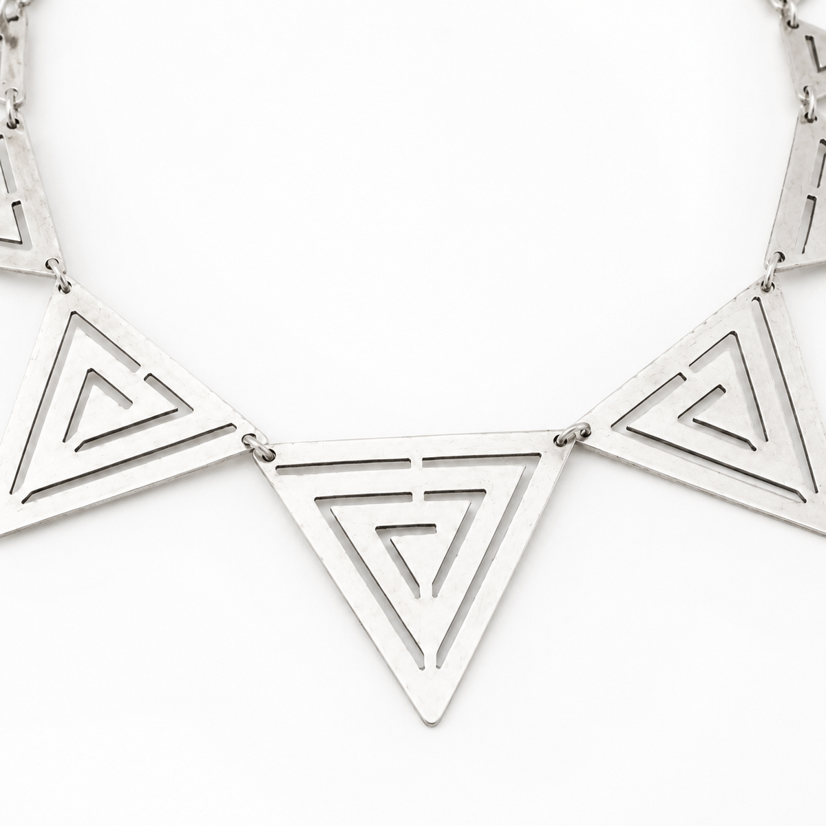Close view of the triangle pendant details and open cutout pattern.