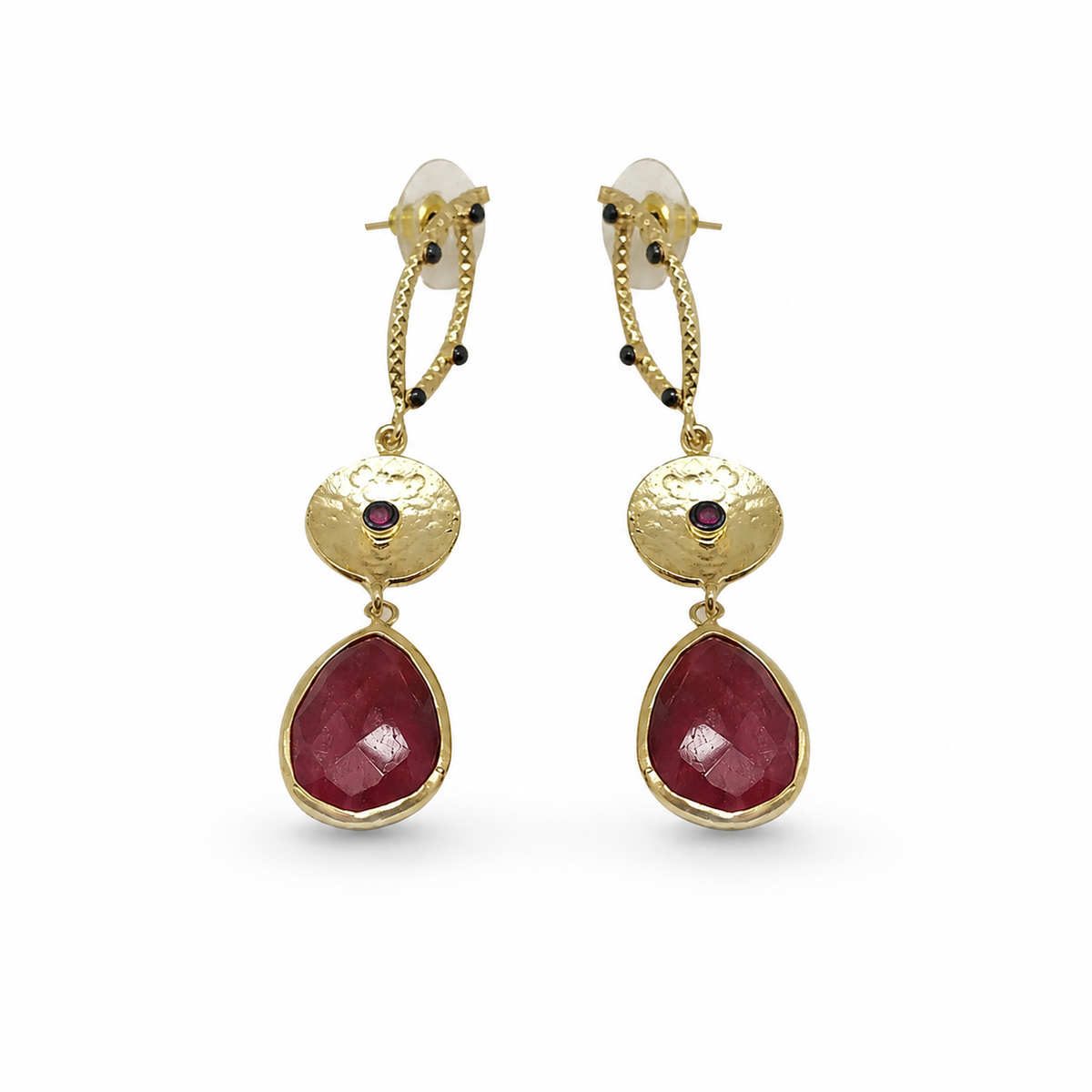 Long gold-plated statement earrings with textured drop links and deep red faceted pendants.