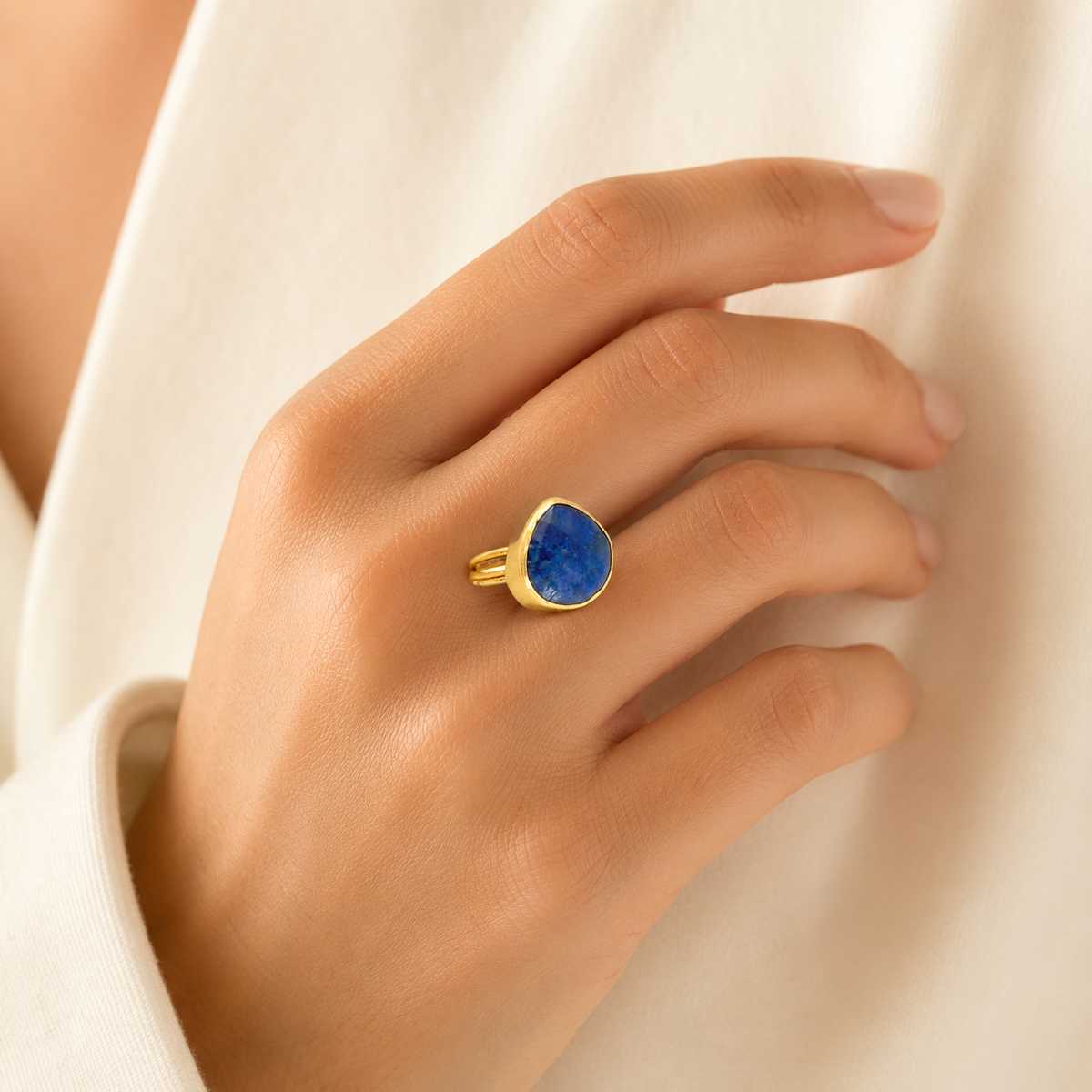 Gold-plated lapis blue teardrop ring shown from the side.