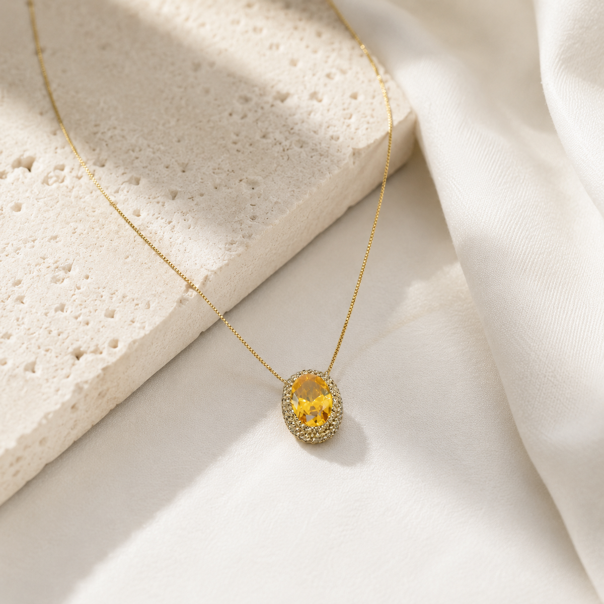 Gold-tone citrine pendant necklace styled against a clean white background.