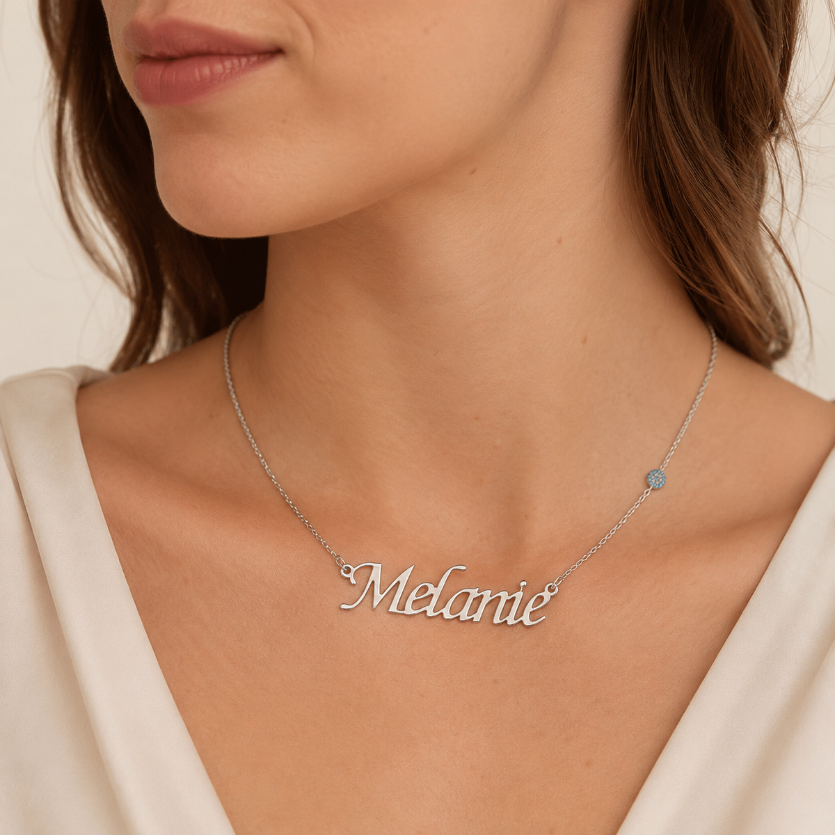 Silver-tone personalized name necklace shown on a white background with a delicate chain.