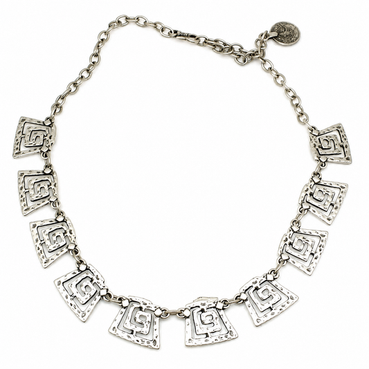 Silver-tone necklace with spiral square links arranged in a bold statement silhouette.
