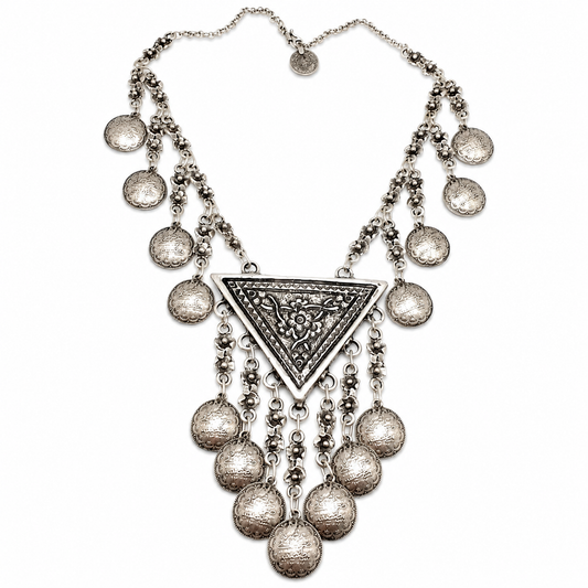 Silver-tone necklace with a crescent centerpiece and teardrop coin fringe.